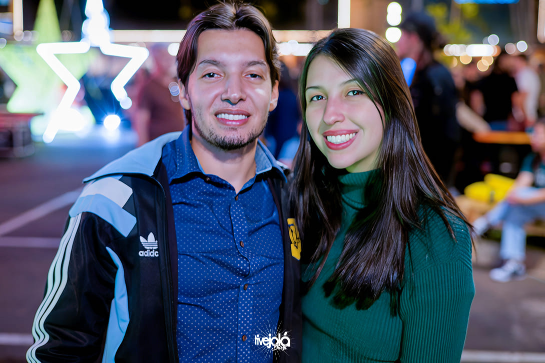 Casal com homem de cavanhaque, cabelos curtos sorrindo, e uma mulher de cabelos longos pretos sorrindo